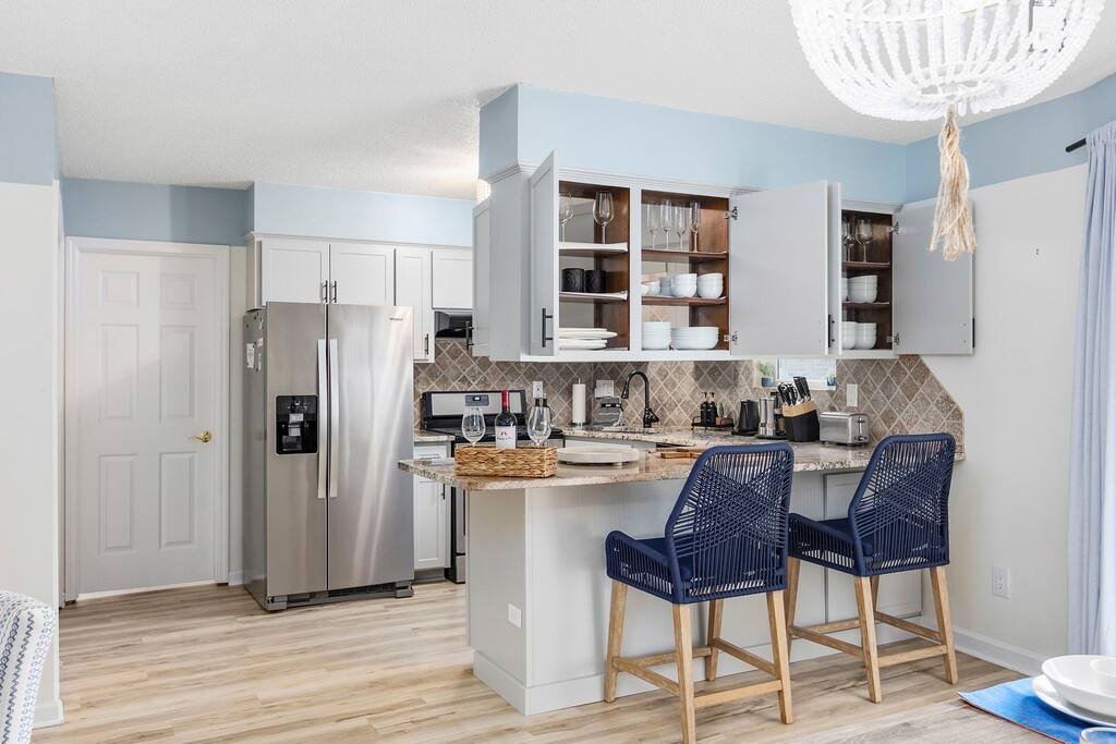 Dual sided door cabinets for access from the dining side as well as the kitchen side with dinnerware for more than 12 people.