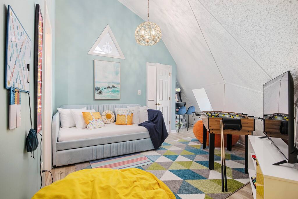 Bedroom 5 features a Trundle Bed with two twin mattresses and a TV.
There's a Scrabble board on the wall.