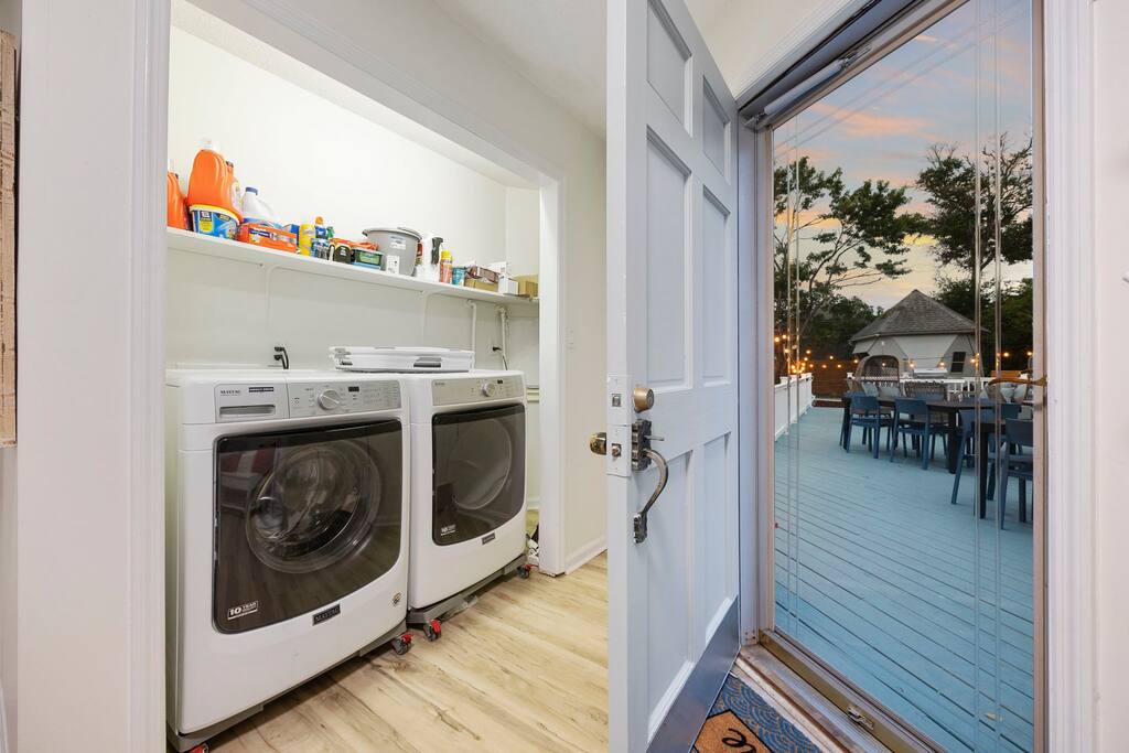 Laundry room. Looking through the backdoor into the backyard deck