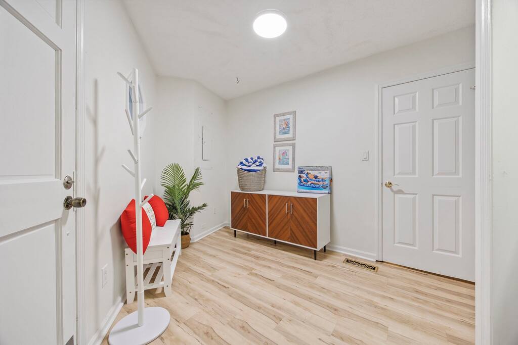Laundry room doubles as a Pool room with the backyard access door on the left. Pool towels, essential beach gear, and backyard games are stored in this roo