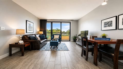 Unwind in the light-filled living room featuring floor-to-ceiling sliding doors with panoram lake and mountian views.