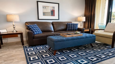Comfortable living room with smart TV, queen sleeper sofa and balcony access.