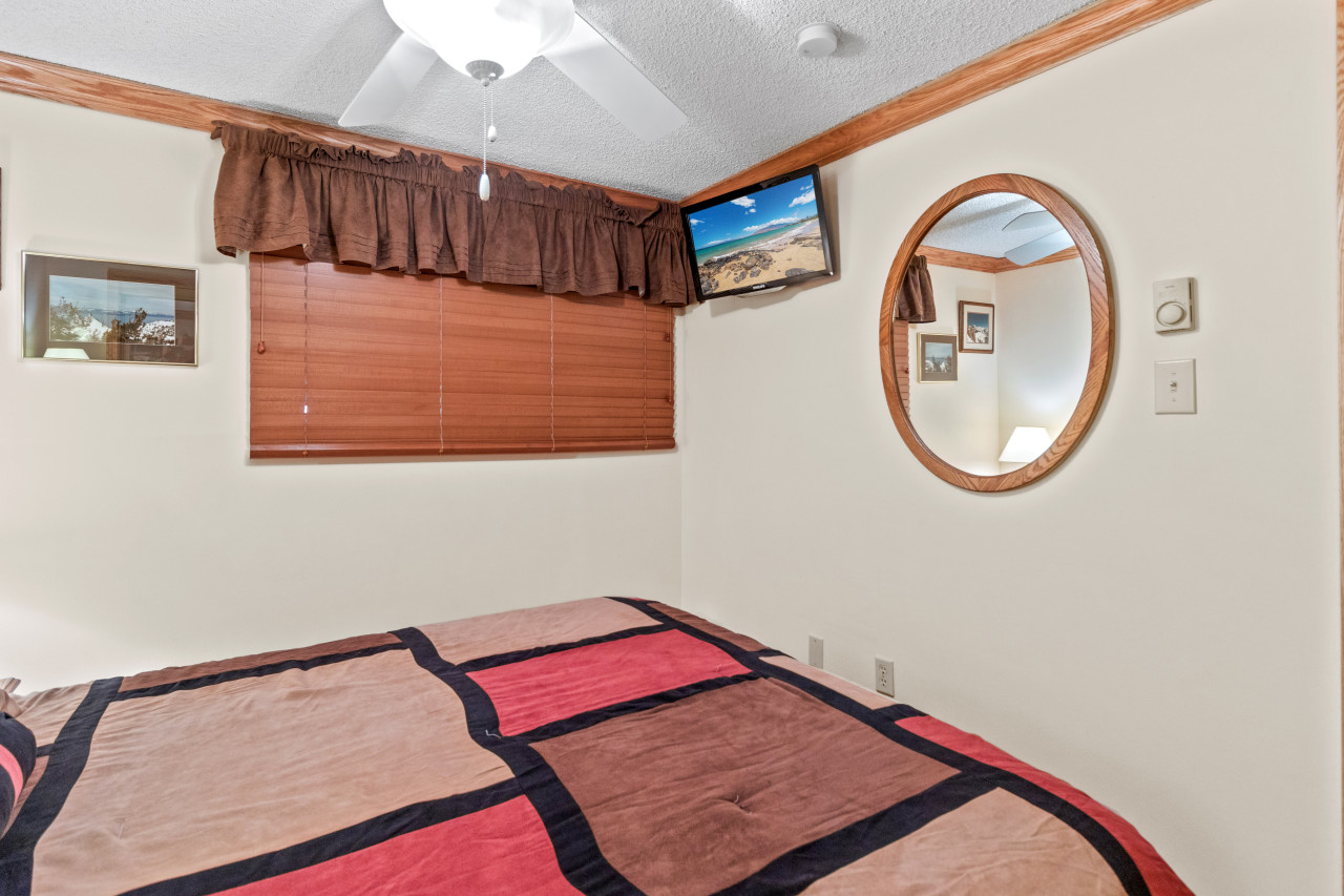 Queen-sized bed in bedroom; with Flat screen Tv