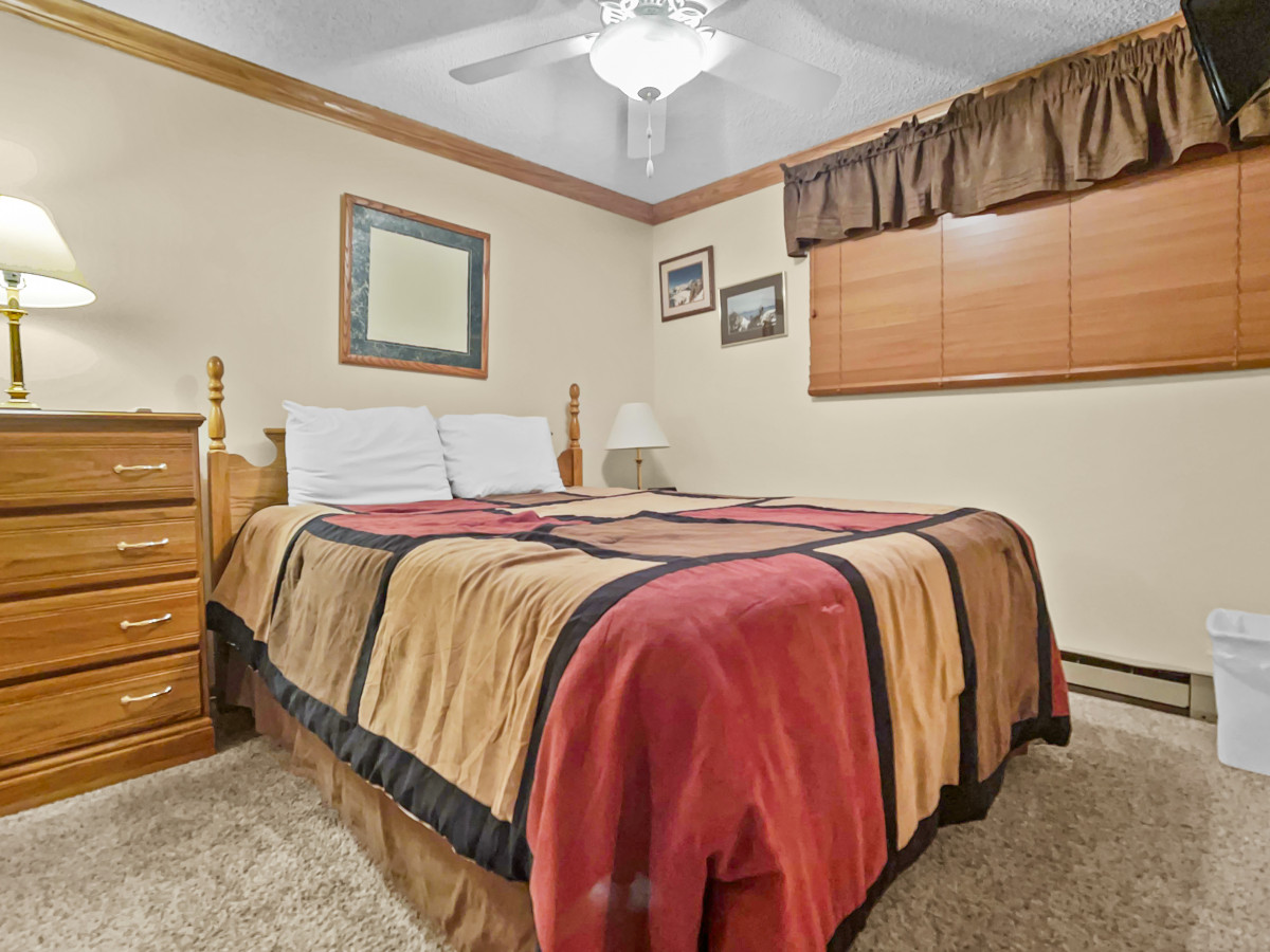 Queen-sized bed in bedroom with Flat Screen TV