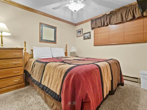 Queen-sized bed in bedroom with Flat Screen TV