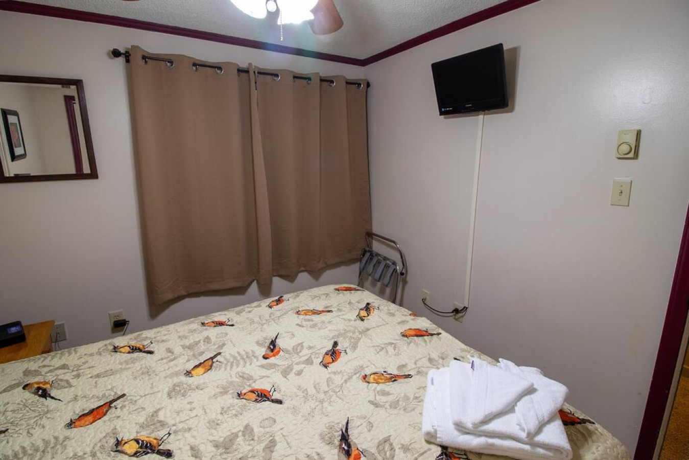 Queen-sized bed in bedroom; Flat screen TV