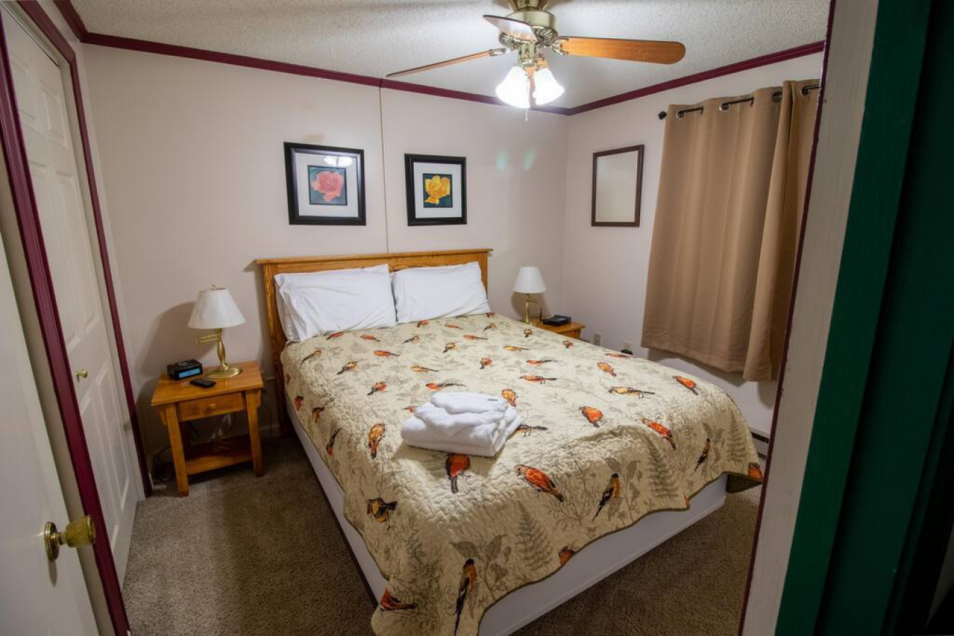 Queen-sized bed in bedroom; Flat screen TV