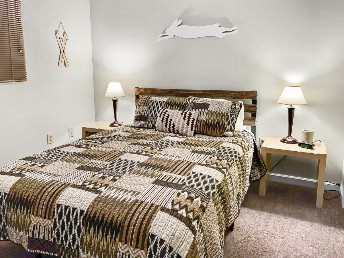 Queen-sized bed in bedroom; with Flat screen TV