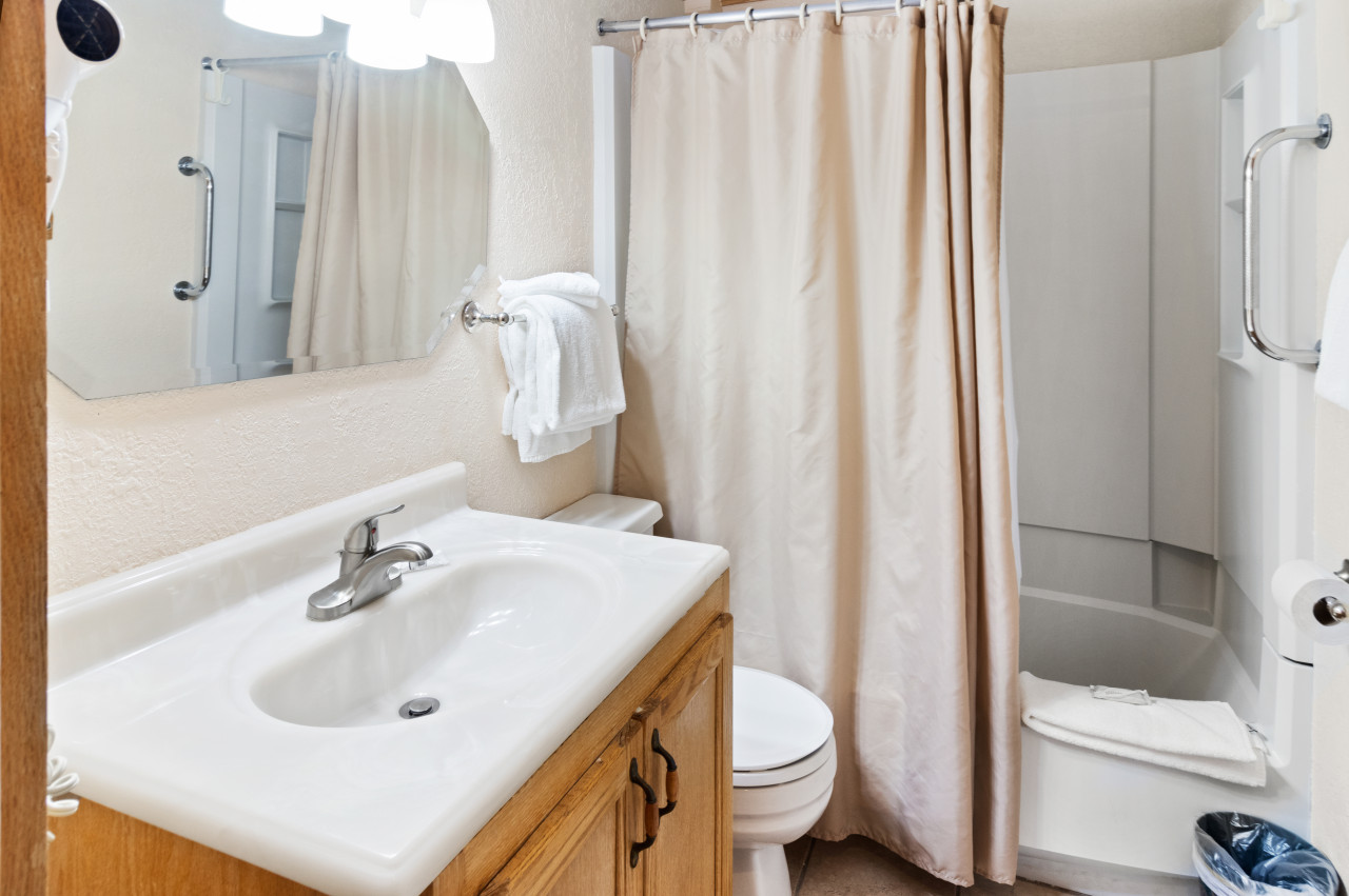 Hallway bathroom includes tub and shower