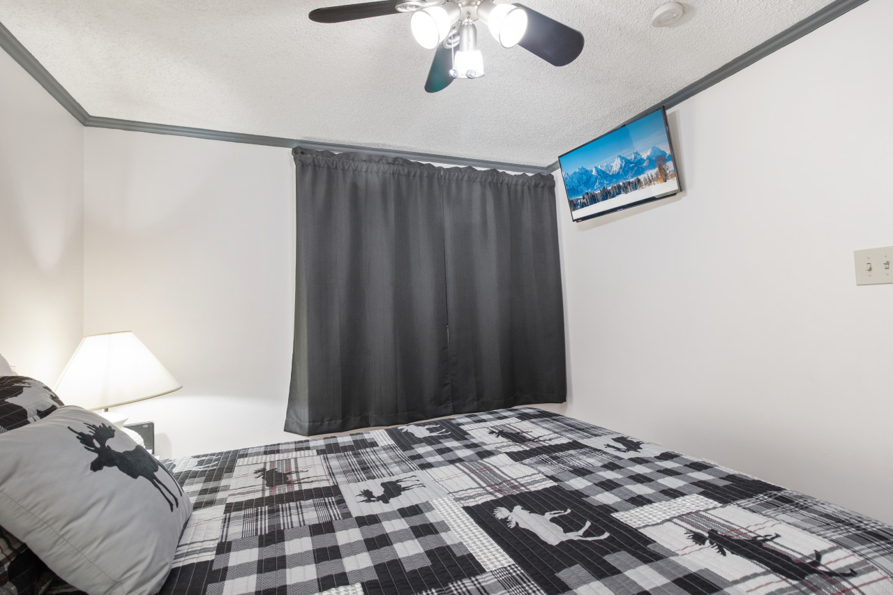 Queen-sized bed in bedroom; Flat Screen TV