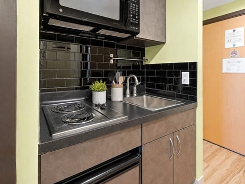 Efficient kitchenette with cooktop, mini fridge and microwave