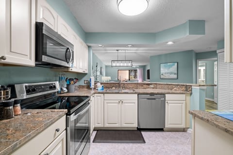 Fully equipped Kitchen looking into the dining and living spaces