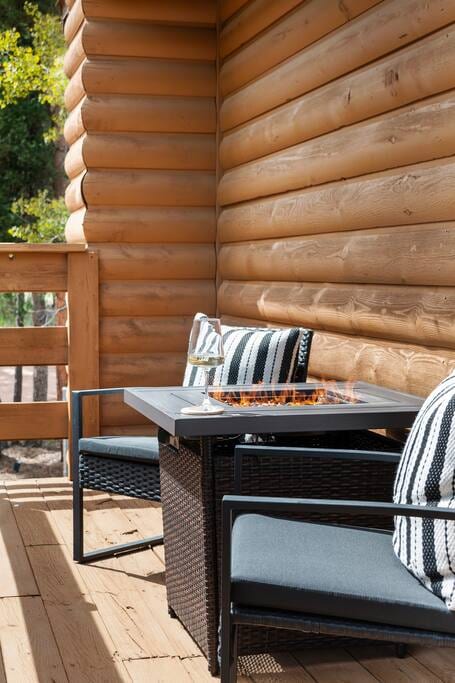 Embrace the great outdoors from the upstairs deck, complete with cozy patio furniture and a fire pit. Immerse yourself in the serene views of the surrounding trees and natural beauty, creating a perfect outdoor oasis.