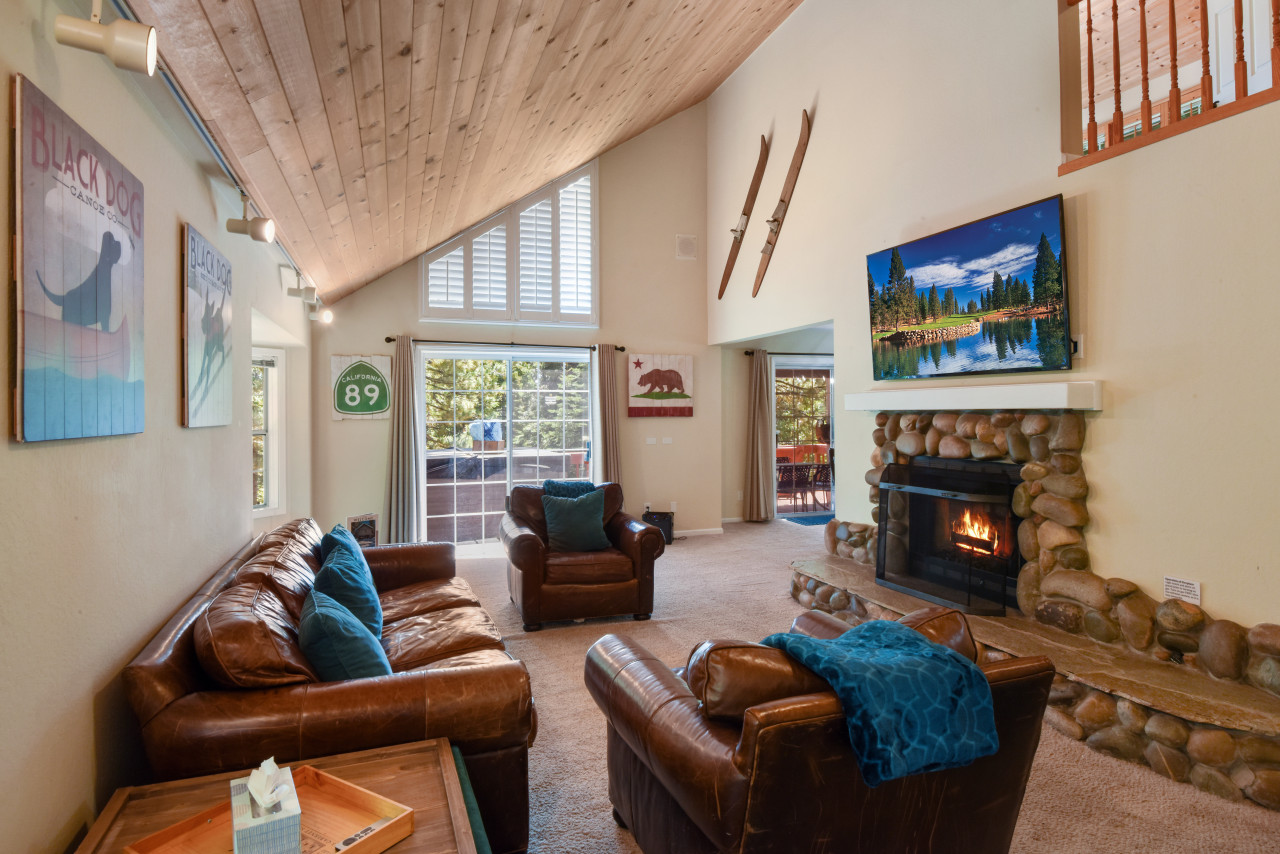 Open Living room with comfortable RH couches, large TV with apple TV