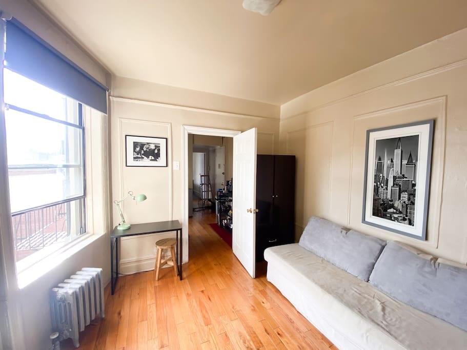 The second room of the apartment can be set up as a bedroom with a comfortable bed or as a living room with a large sofa. Inside the room, there is a large TV, a spacious wardrobe for storing clothes, and a work desk next to the window.