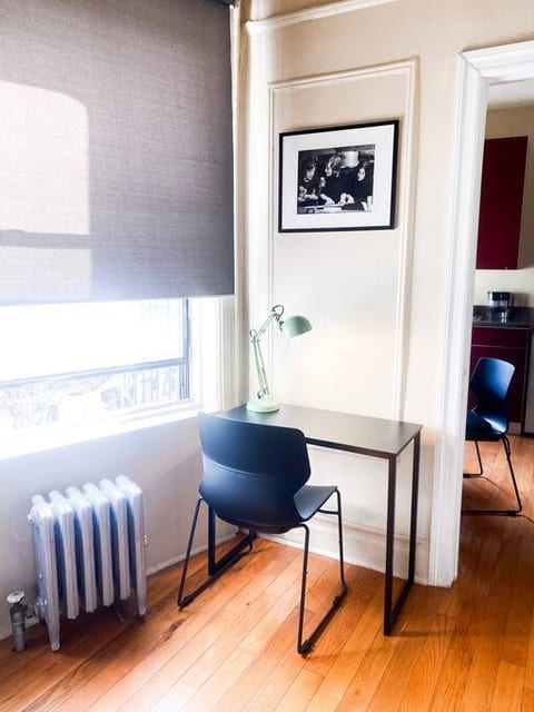 It's a small work desk next to the window. The entire apartment has huge windows, and the sun lights us up all day long.