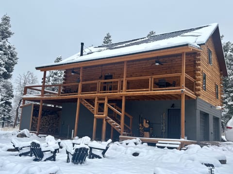 Winter at Bear Necessities Lodge. Snow-covered pines, cozy evenings by the wood stove, and Angel Fire Resort just minutes away.