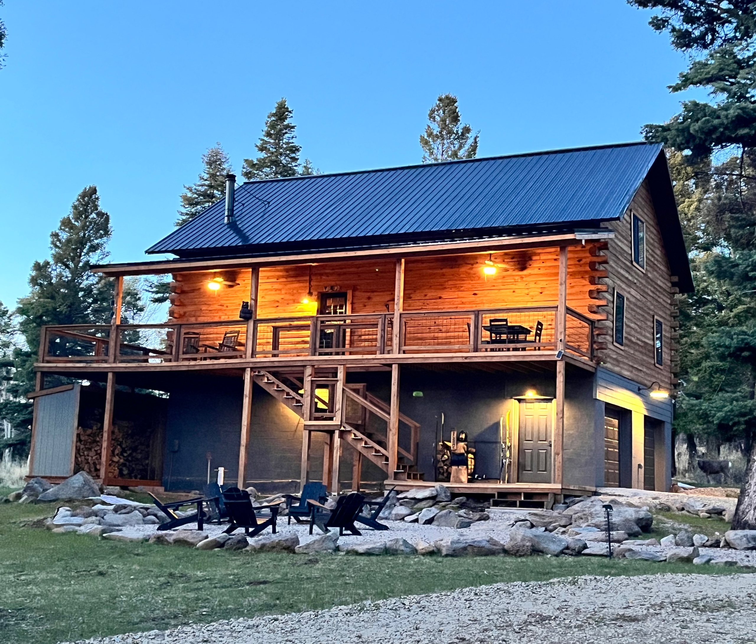 The nighttime picture of Bear Necessities Lodge captures the essence of a warm, inviting log cabin. The lodge stands as a beacon of comfort and hospitality amidst the serene, darkened landscape.