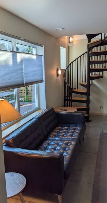 Living room with side tables and big window for afternoon sunlight.