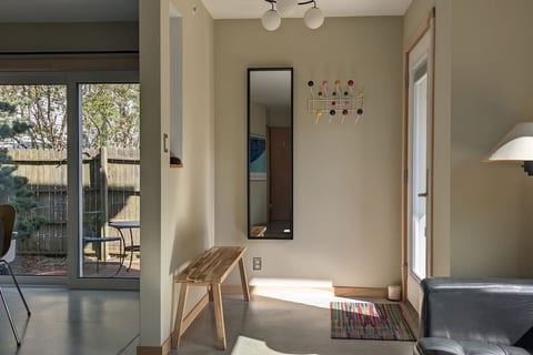 Entry and dining area with sliding door connecting to guests' private garden patio.