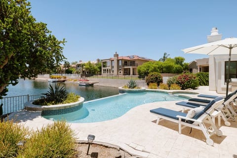 Enjoy the infinity edge pool and pool loungers overlooking the lake.