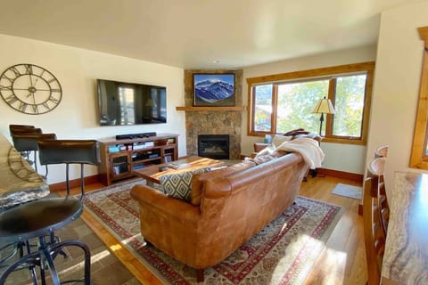 Cozy living room with 65” Smart TV with cable and DVD player, gas fireplace, and games