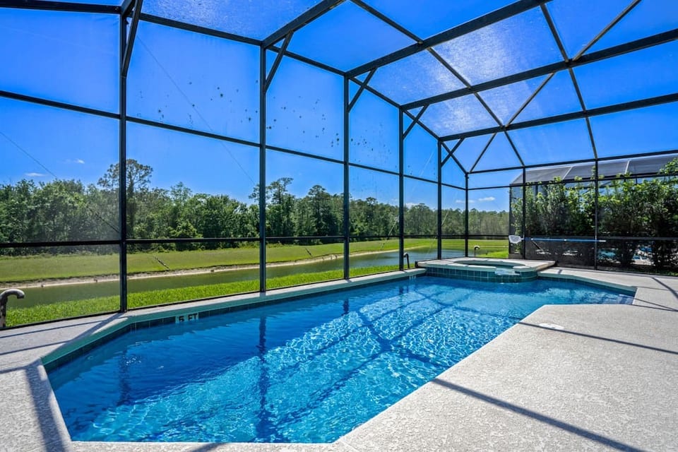 Pool deck with water and woodland view