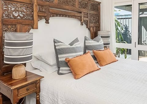Bedroom 2 - king-sized bed with large screened sliding door to outside.