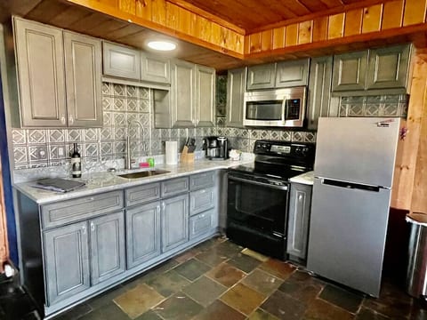 kitchen, yes plates, silverware and grilling utensils and glasses