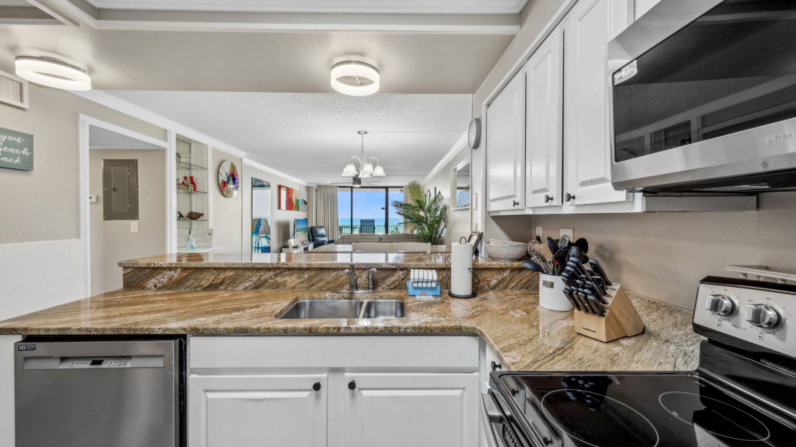 Fully equipped kitchen with granite countertops, stainless appliances, and Gulf views—perfect for cooking and staying connected.