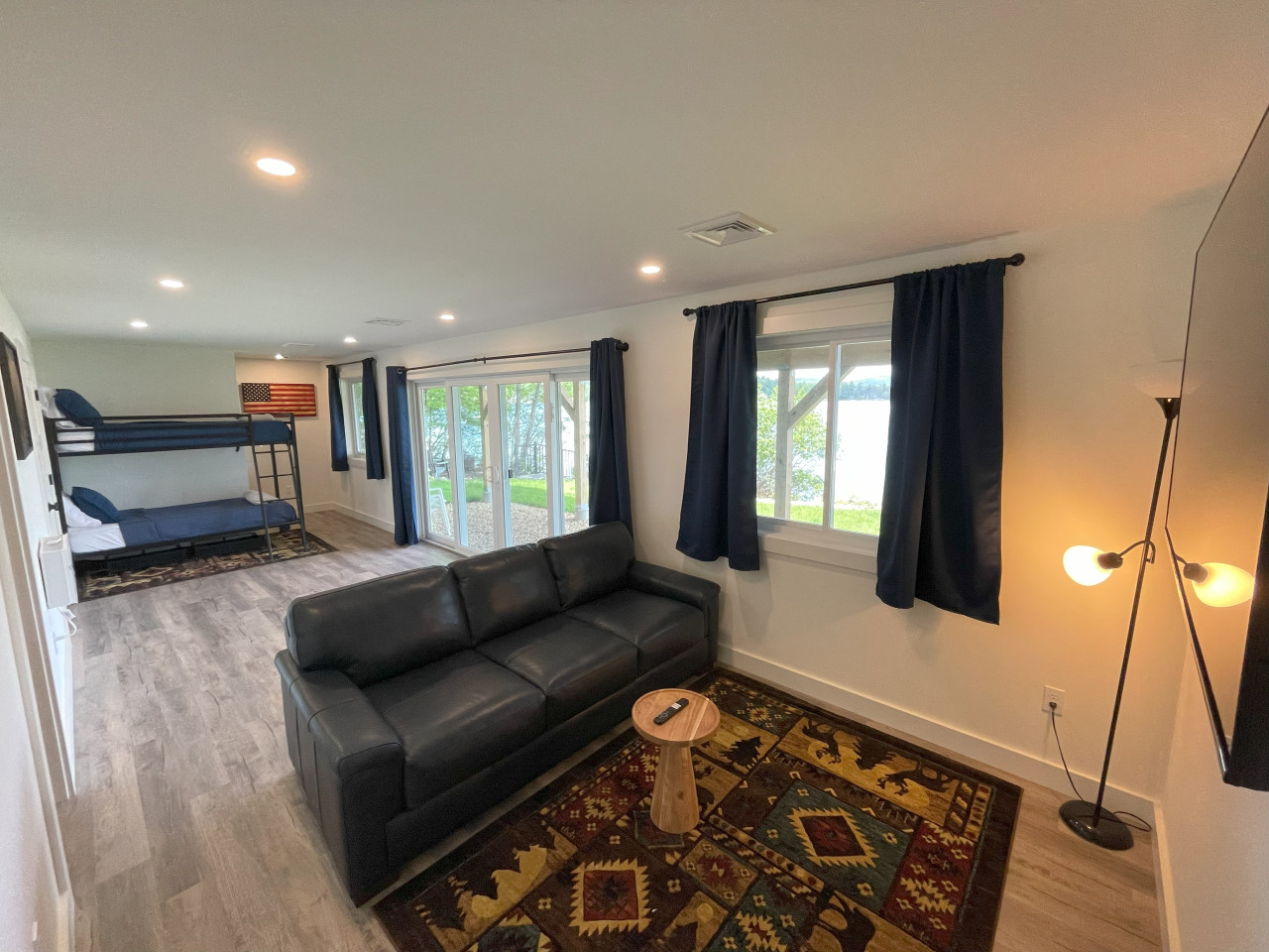 Lower Level Bedroom with pull-out queen sofa bed & walk-out sliders to the water. Lower Level Bedroom with pull-out queen sofa bed & walk-out sliders to the water. - Merrymeeting Lake - New Luxury Waterfront Home w/ Private Dock & A/C - New Durham
