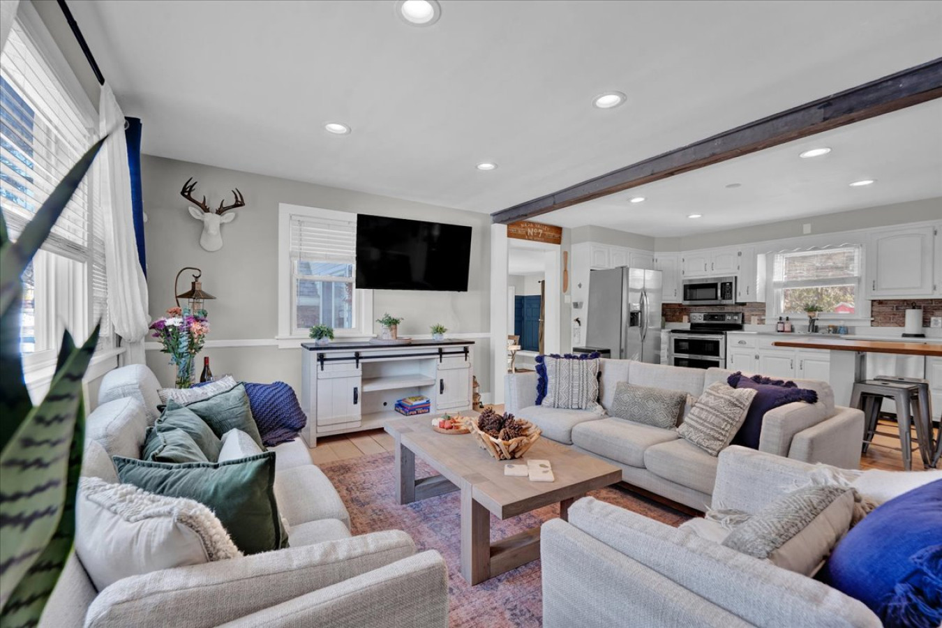 Spacious open-concept living room with ample seating and a Smart TV—perfect for relaxing and gathering with loved ones!