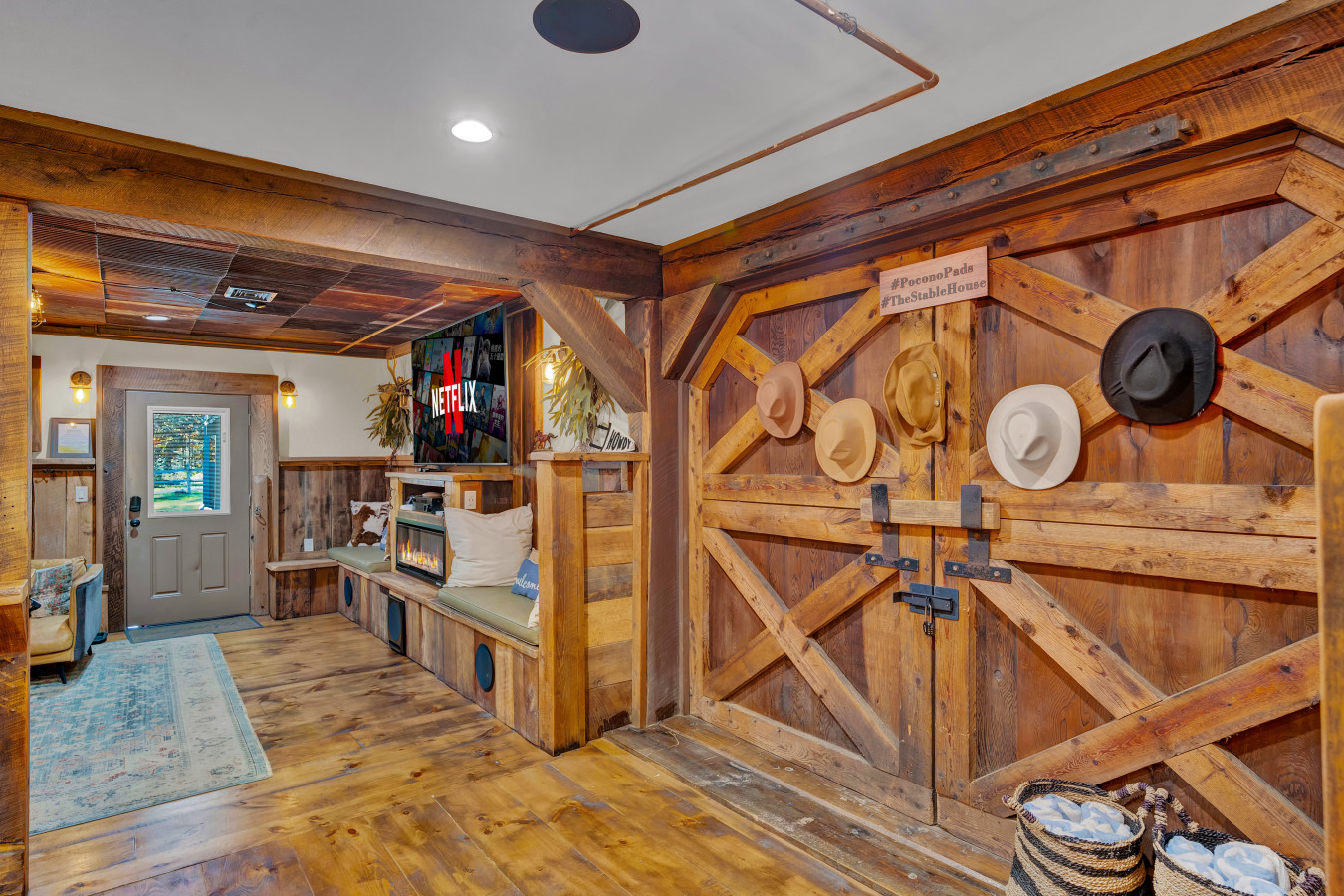 Charming Dutch door transformed into a unique display for vintage horse hats — adding rustic character and equestrian flair to the space.