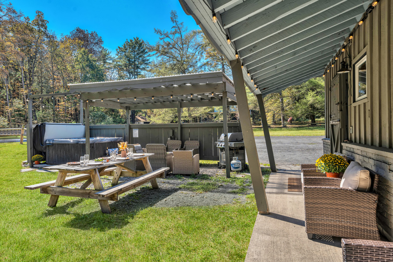 Gather around the rustic wooden outdoor table — perfect for meals, games, or simply enjoying the fresh air.