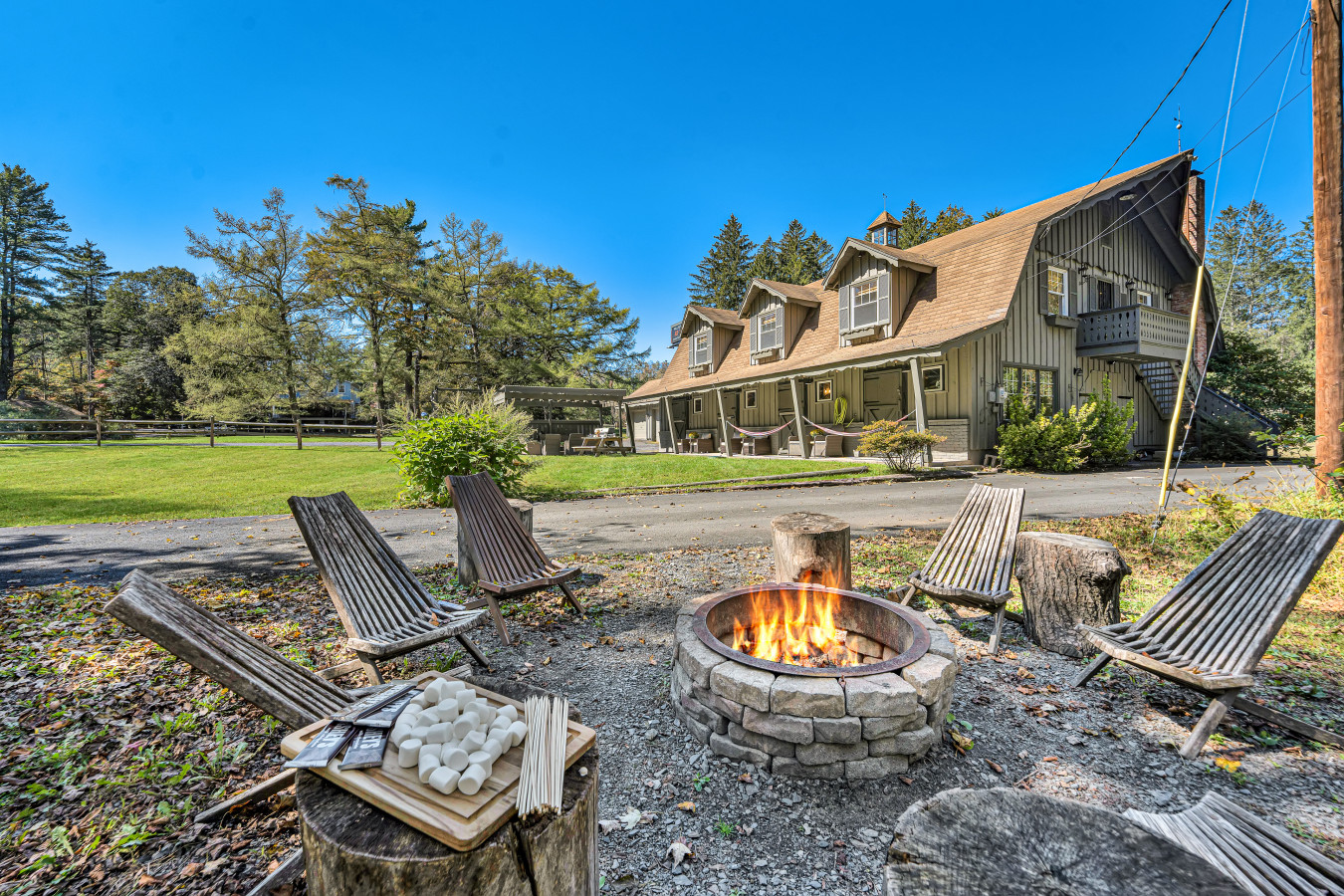 Creekside firepit magic — cozy up by the flames and let the soothing sound of the water flow create the perfect backdrop for your evening.
