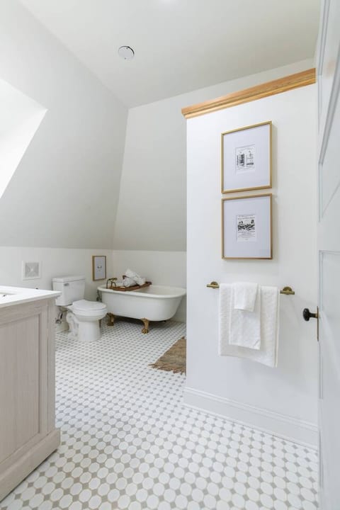 This freestanding masterpiece is a celebration of design, its smooth porcelain surface adorned with gleaming, polished chrome fixtures that harken back to a bygone era.
