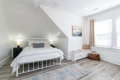 Our bedroom, adorned with pristine white sheets, is a serene oasis where tranquility and comfort merge into a haven of restful reprieve.