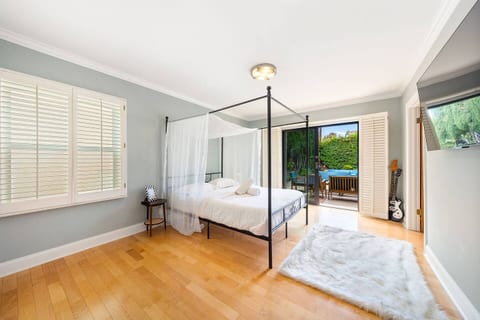 Queen-size bed with an elegant canopy, offering a cozy retreat with dreamy California vibes.