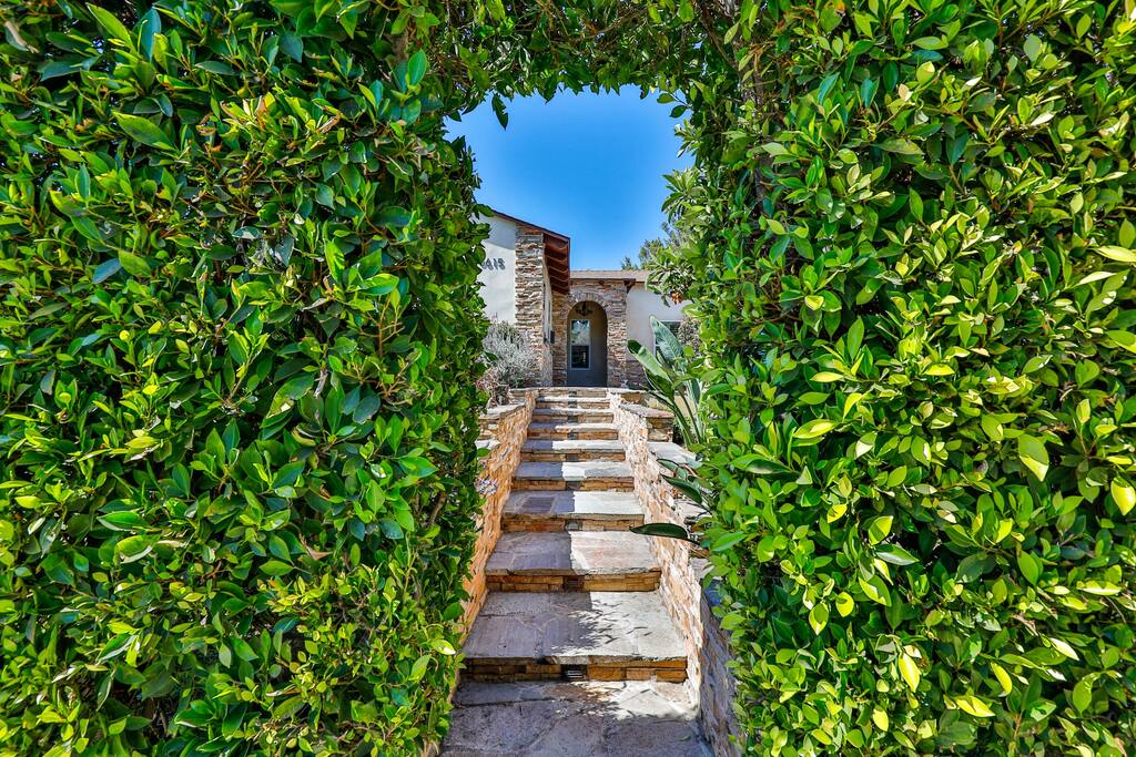 Stunning entrance enveloped by an enchanting garden to capture your heart.