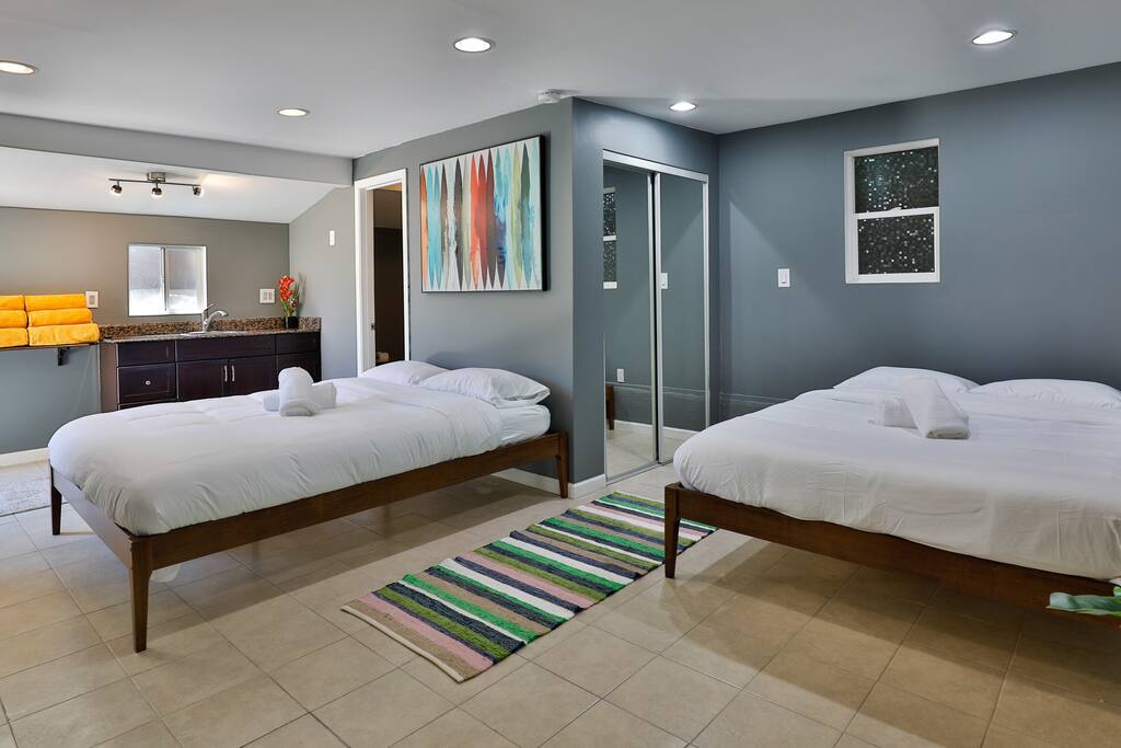 Spacious and welcoming guest room with two comfortable double beds for your convenience.