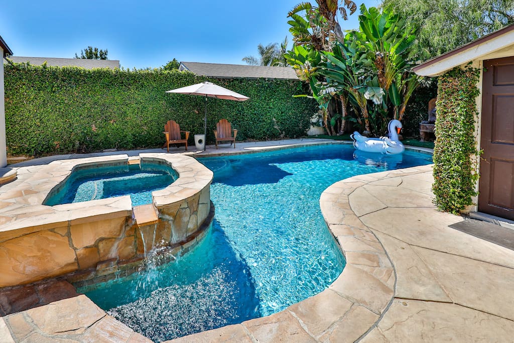 Private heated pool and spa, along with an outdoor seating area, ideal for hosting and relaxation.