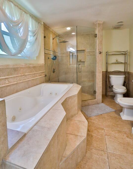 Experience the luxury of a generously-sized bathroom with a generously-sized shower, and abundant natural light. Discover a haven of comfort and sophistication during your stay room.