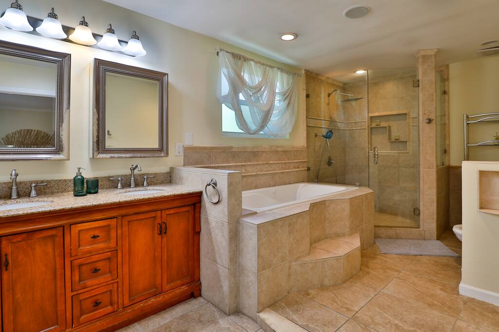 Experience the luxury of a generously-sized bathroom with a generously-sized shower, and abundant natural light. Discover a haven of comfort and sophistication during your stay room.