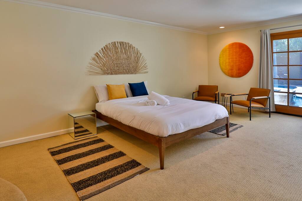 An expansive and lavish suite with a queen-size bed and exceptional natural light.