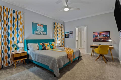 Primary 50's theme bedroom with King bed and workstation desk and chair.  