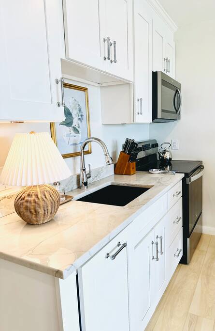 Check out our newly renovated Chef’s Kitchen featuring white shaker cabinets, quartz counters, a full-size SS fridge, stove, microwave, and a Bosch dishwasher. Perfect for whipping up anything from casual bites to a gourmet meal!


