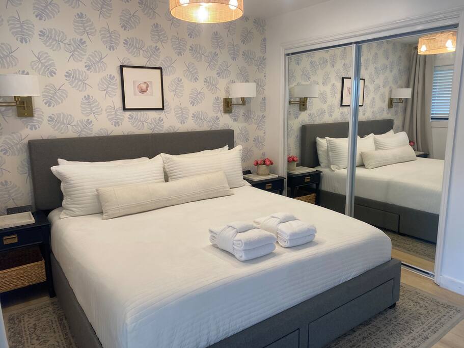 Clean, White & Bright!  

King Bed, 55” Samsung Frame TV, Double Closet, 6 Drawer Dresser, Fandelier, Block-out Pleated Drapery, and 2 Vintage Bamboo Nightstands.