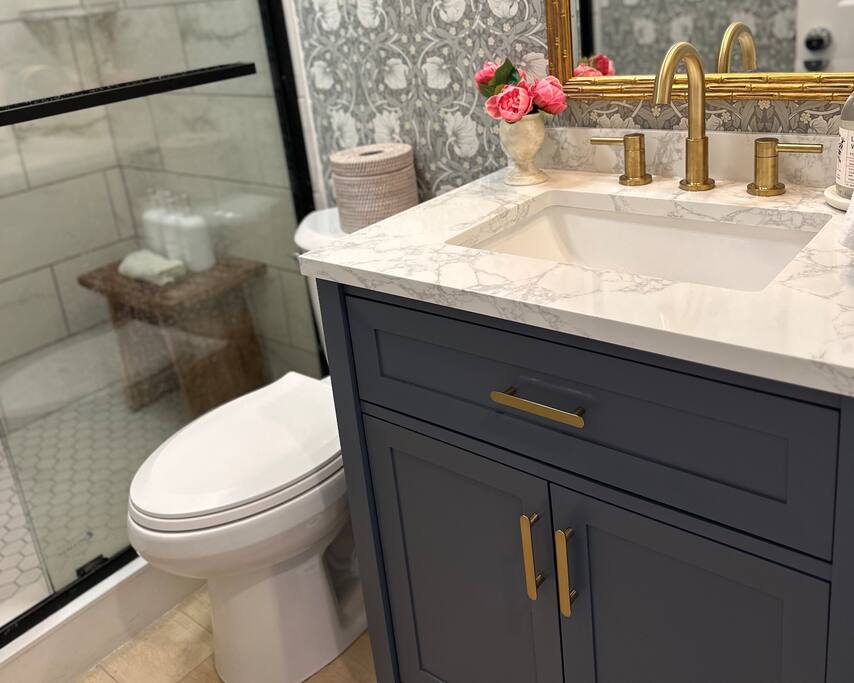Classic and Timeless Navy & Gold make this Bathroom a true jewel box.  English wallpaper by William Morris, and a Walk-in Shower with new Tile and a Bamboo Bench make it feel like a Spa Retreat!