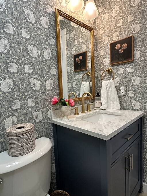 "Escape to serenity in this luxe, English coastal-inspired spa bathroom. With its moody tones and modern touches, every corner invites you to indulge, unwind, and relax.”