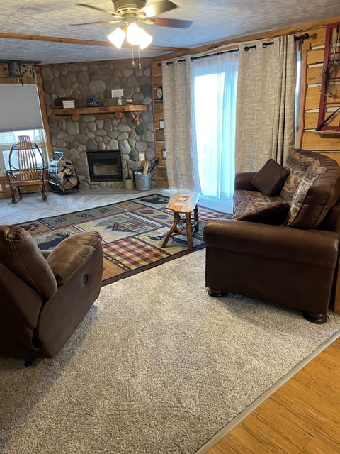 Living room with lake view. 
 Smart TV with DirecTV. 
 Seats up to seven people comfortably.  Two rocker recliners.  Wood burning fireplace including wood for your stay.  Ceiling fan and blind/curtains for your privacy.